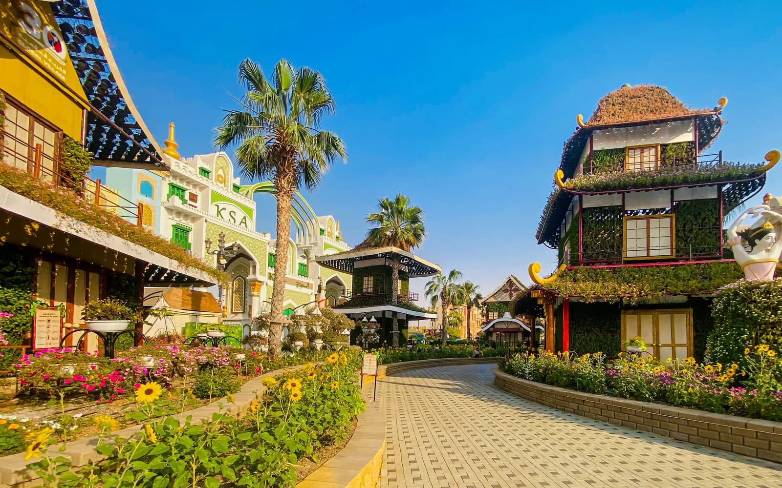 Dubai'de açık hava festival alanında ahşap yel değirmeni, renkli yiyecek standı ve yeşillik